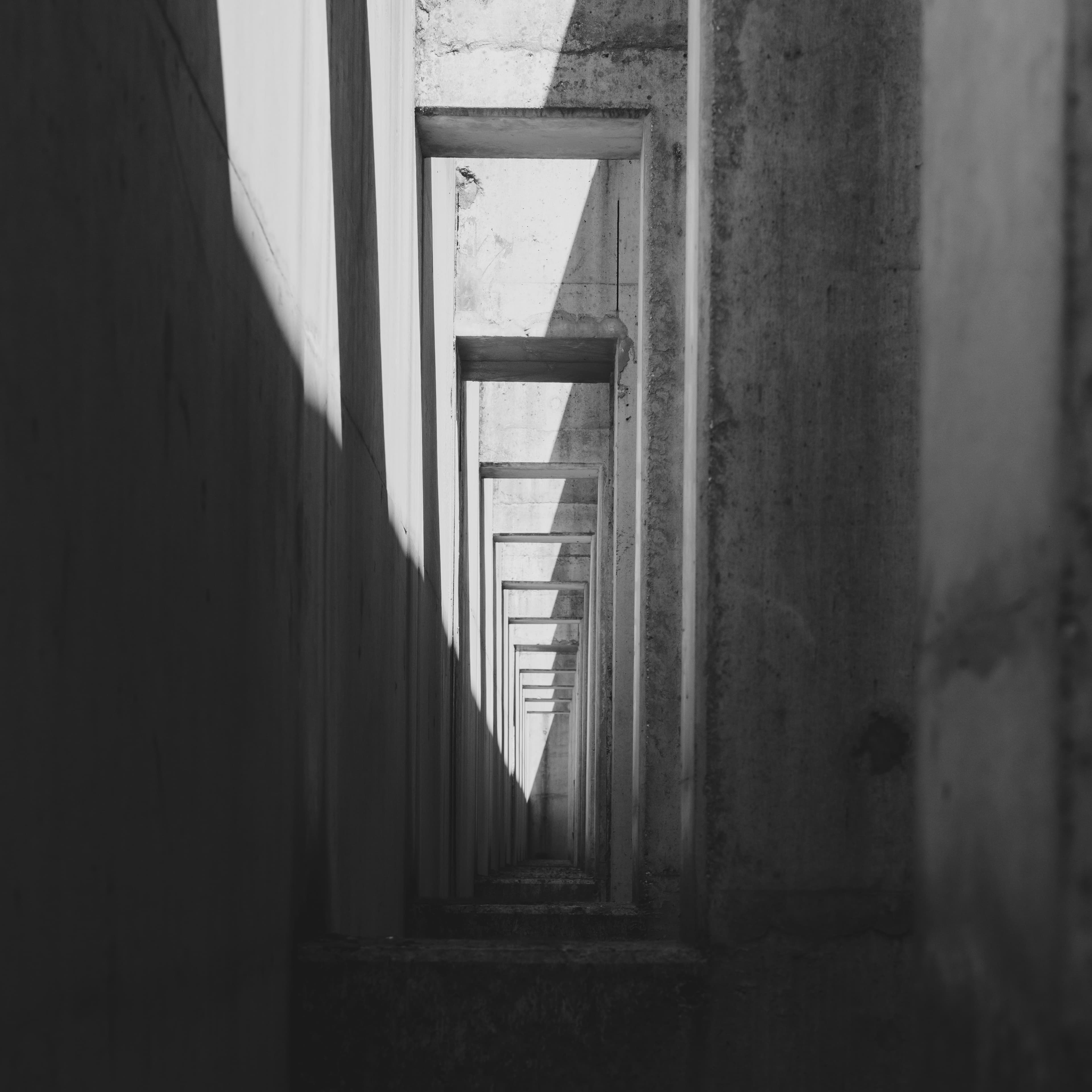 Brutalist architectural structure with concrete surfaces and shadow